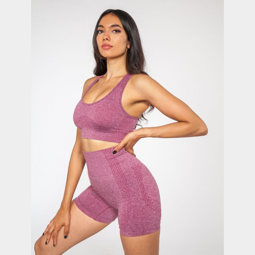 Wine Berry seamless gym shorts worn by a model in a studio