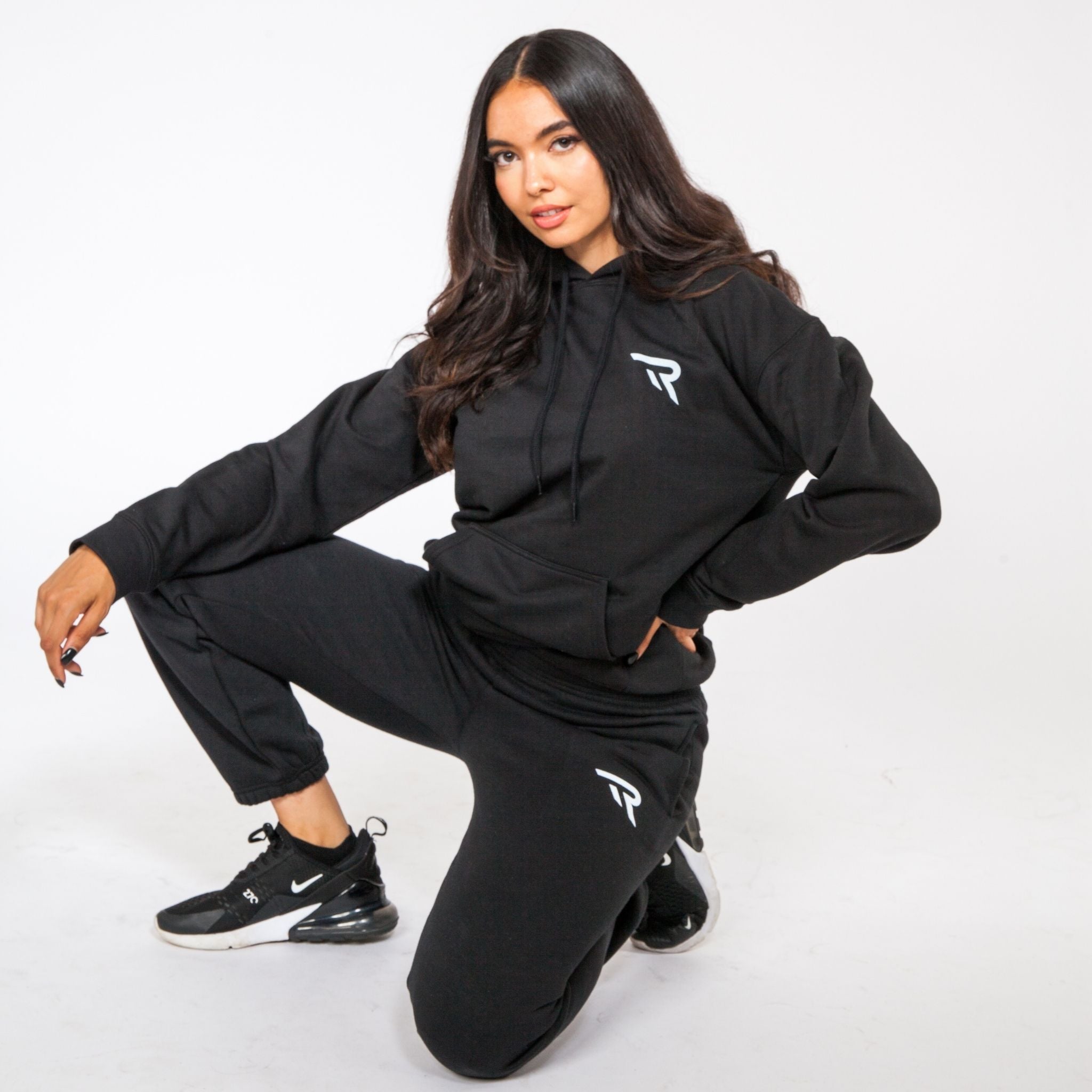 Female posing black oversized hoodie in studio